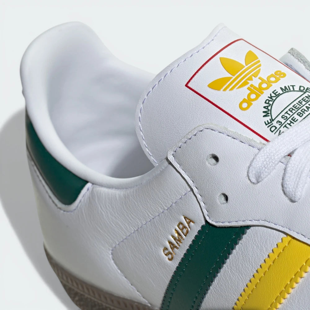 White Adidas Samba sneaker with green and yellow accents on a white background