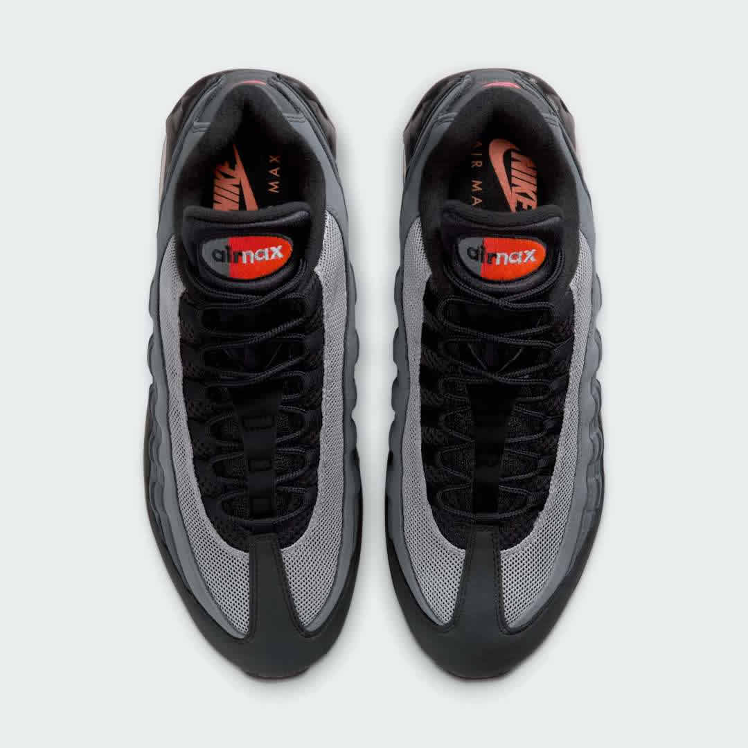 Top-down view of a pair of Nike Air Max 95 OG Men's running shoes in black, highlighting their iconic silhouette and lacing system.