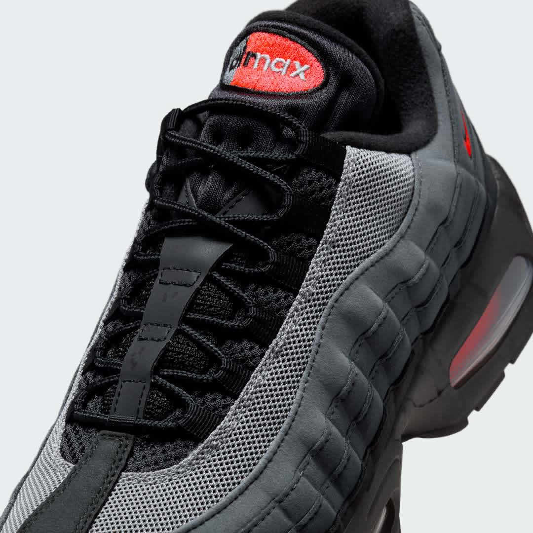 Close-up zoom on the front of the Nike Air Max 95 OG Men's running shoes, showing the intricate lacing system, mesh tongue, and layered overlays.