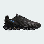 Nike Air Max DN Men's running shoes in black and grey, side profile showing visible Dynamic Air unit in the heel, textured upper, and blue accents.