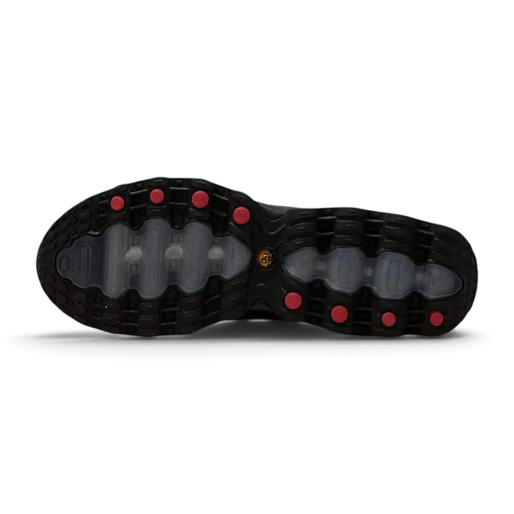 View of the outsole of the Nike Air Max DN Men's black running shoes, showing the durable rubber tread pattern and the unique design of the visible Dynamic Air pods.