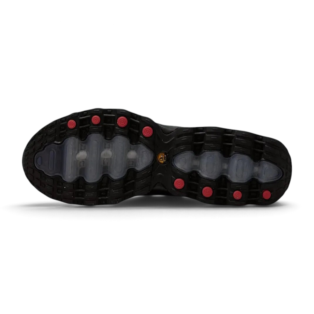 View of the outsole of the Nike Air Max DN Men's black running shoes, showing the durable rubber tread pattern and the unique design of the visible Dynamic Air pods.