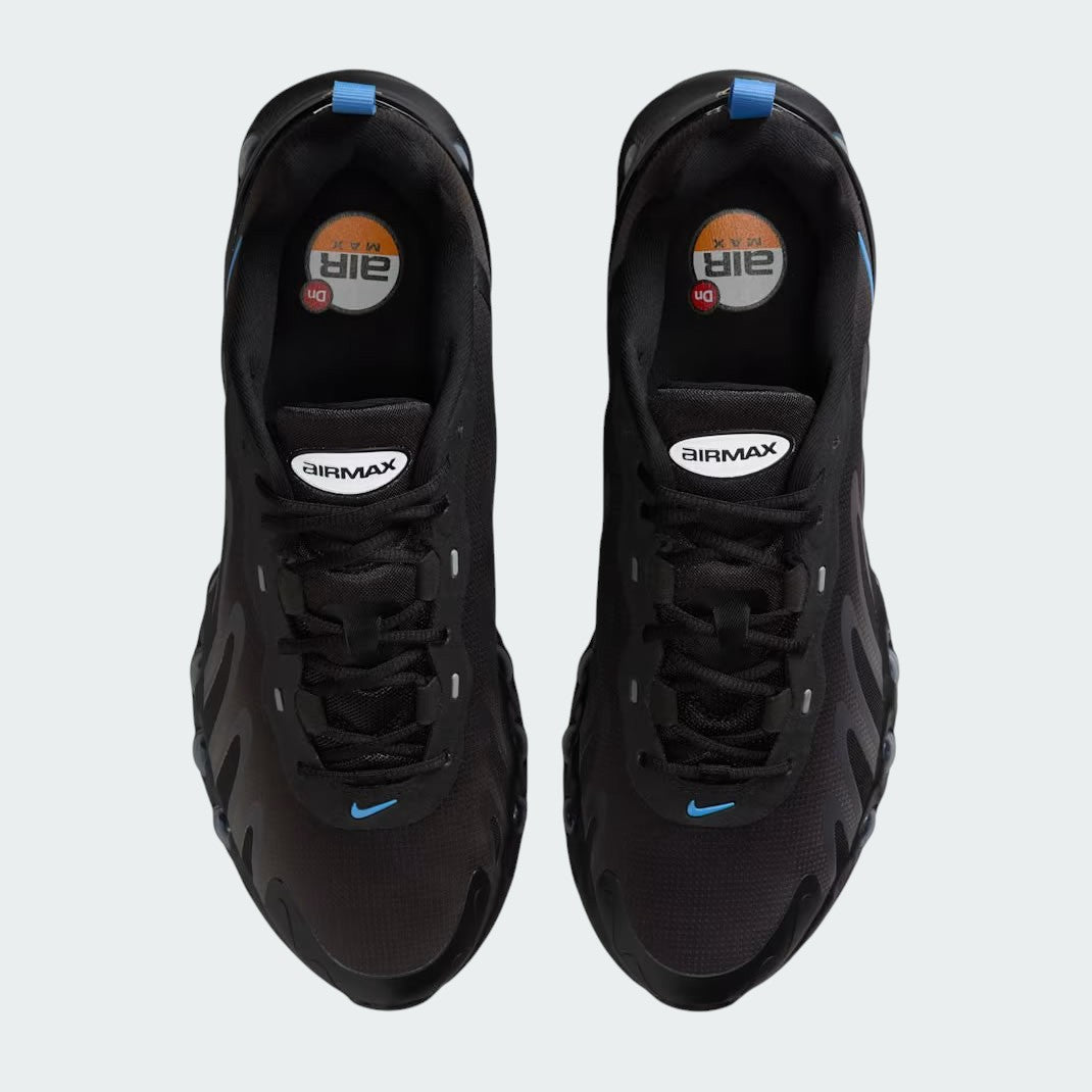Top-down view of a pair of Nike Air Max DN Men's running shoes in black, highlighting their futuristic design and lace-up closure.