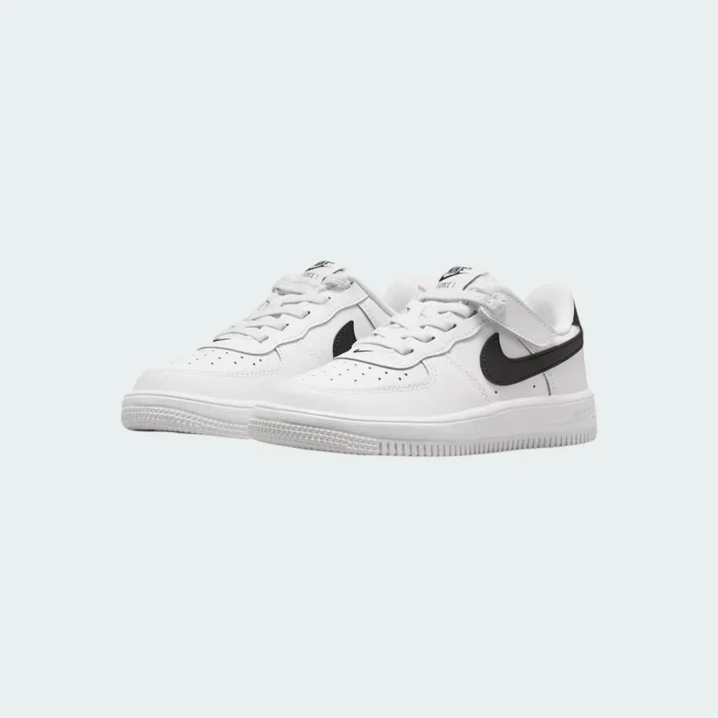 Angled view of two Nike Air Force 1 Low EasyOn Kids' trainers in white and black, side by side, showcasing their timeless design and clean aesthetic.