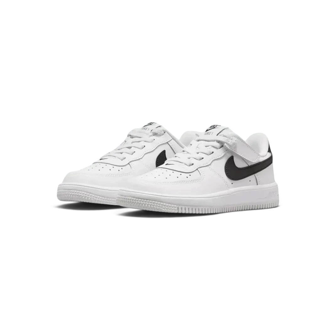 Angled view of two Nike Air Force 1 Low EasyOn Kids' trainers in white and black, side by side, showcasing their timeless design and clean aesthetic.