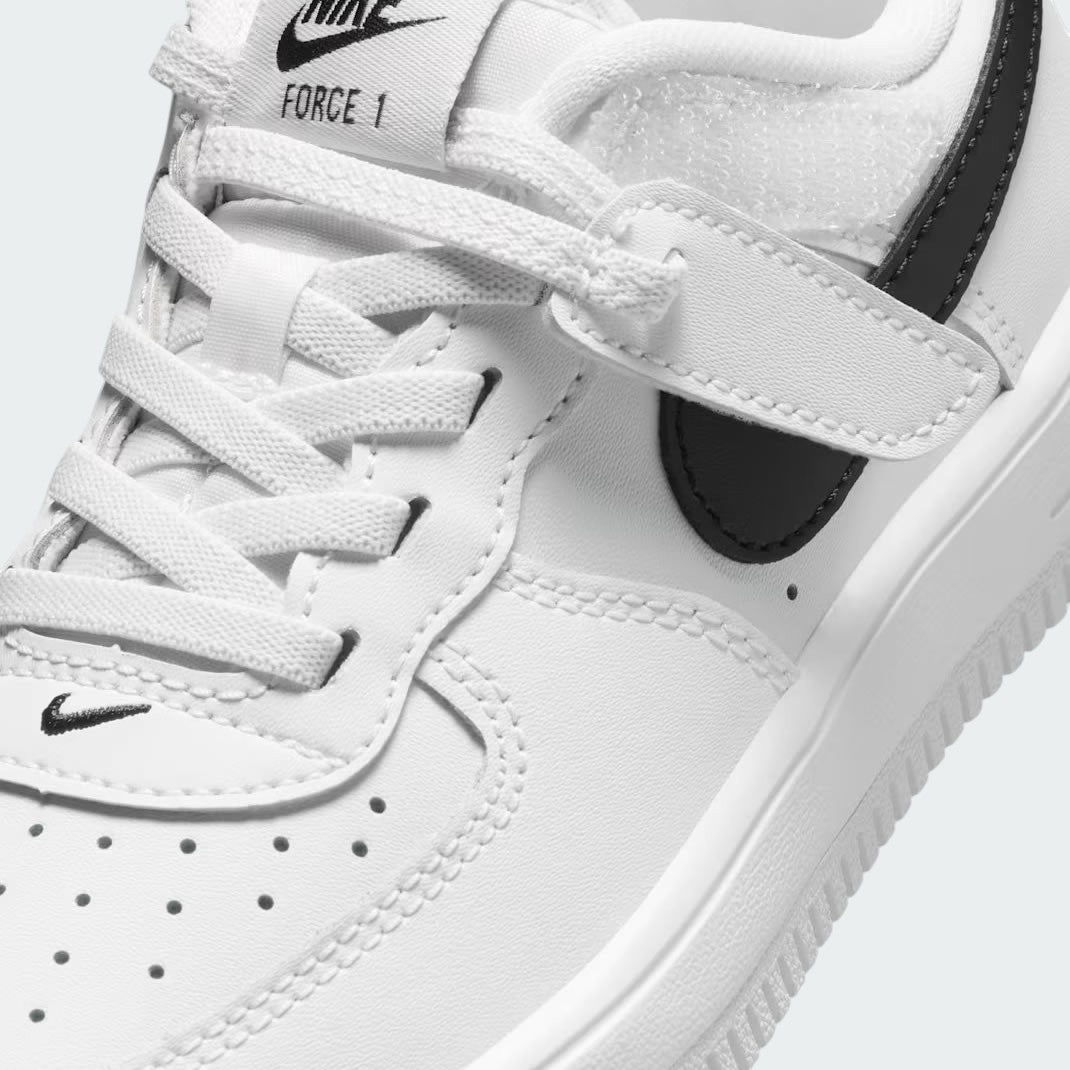 Close-up zoom on the front of the Nike Air Force 1 Low EasyOn Kids' trainers, showing the perforated toe box, lace-up system, and texture of the leather upper.