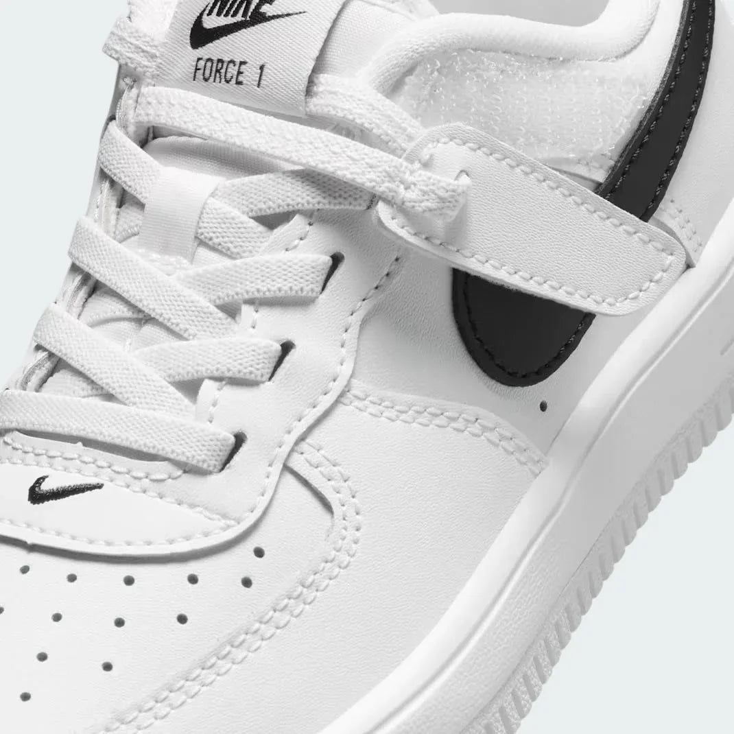 Close-up zoom on the front of the Nike Air Force 1 Low EasyOn Kids' trainers, showing the perforated toe box, lace-up system, and texture of the leather upper.