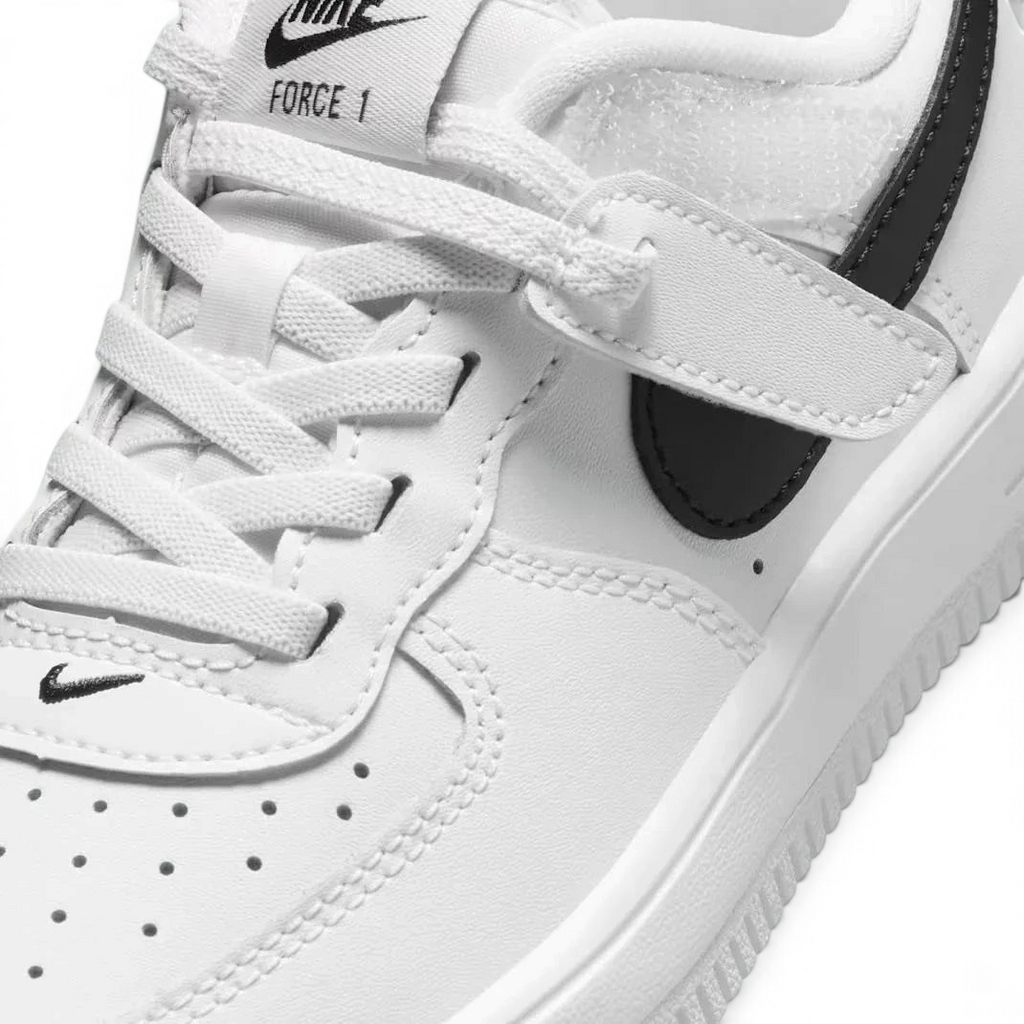 Close-up zoom on the front of the Nike Air Force 1 Low EasyOn Kids' trainers, showing the perforated toe box, lace-up system, and texture of the leather upper.