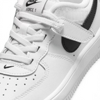 Close-up zoom on the front of the Nike Air Force 1 Low EasyOn Kids' trainers, showing the perforated toe box, lace-up system, and texture of the leather upper.