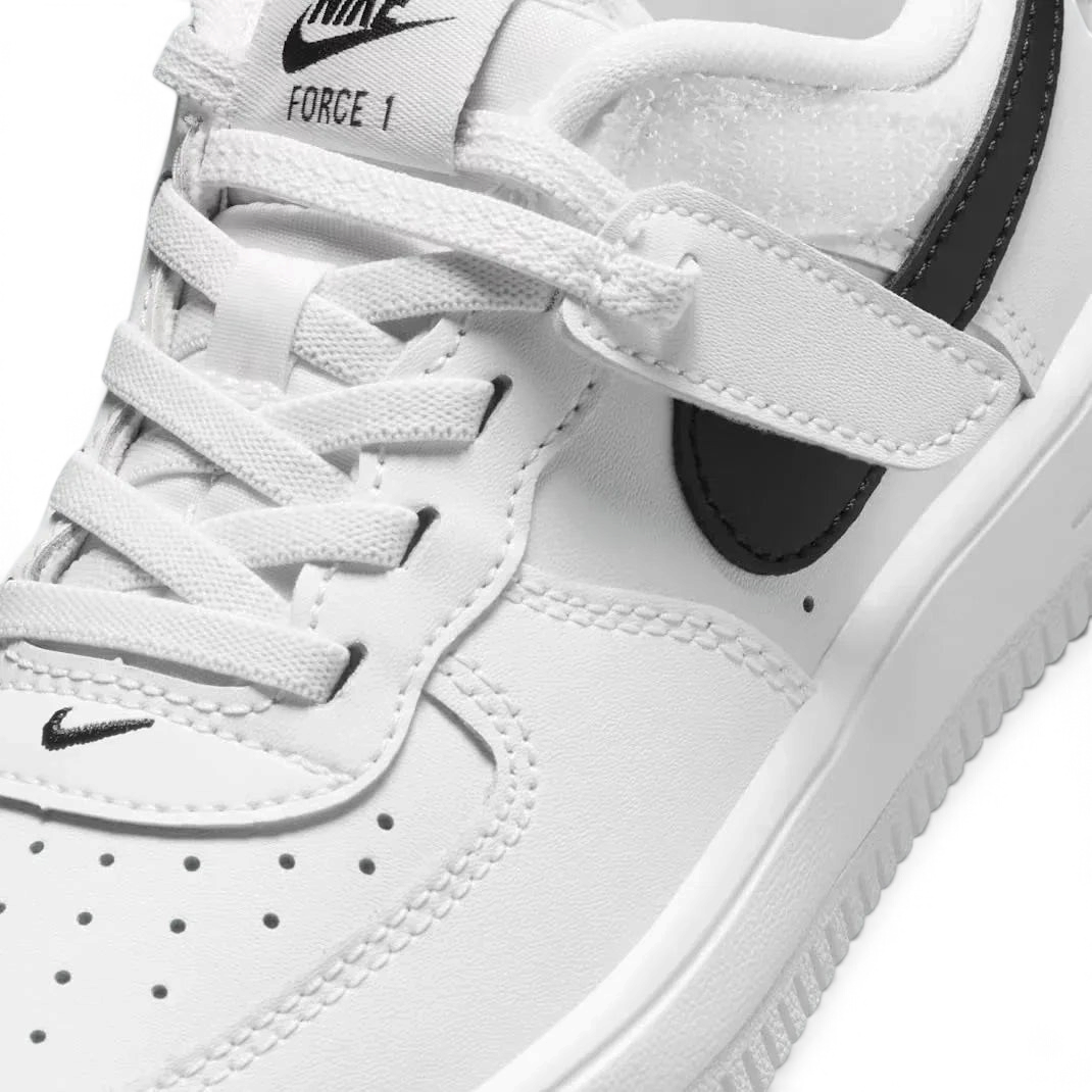 Close-up zoom on the front of the Nike Air Force 1 Low EasyOn Kids' trainers, showing the perforated toe box, lace-up system, and texture of the leather upper.
