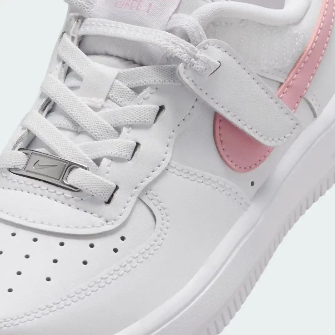Close-up zoom on the front of the Nike Air Force 1 Low EasyOn Girls' white trainers, showing the perforated toe box, lace-up system, and texture of the leather upper.