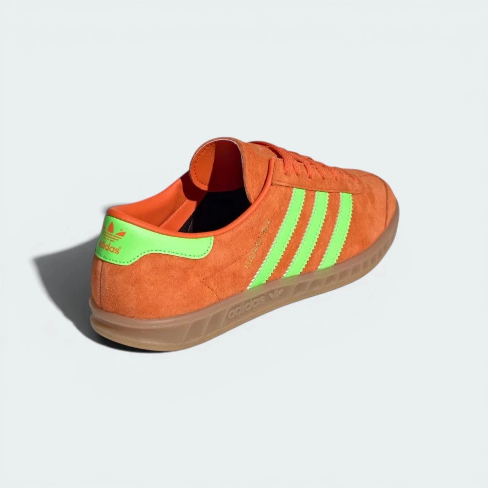 Rear view of the shoes, focusing on the Solar Green heel tab and the structured, supportive ankle collar.