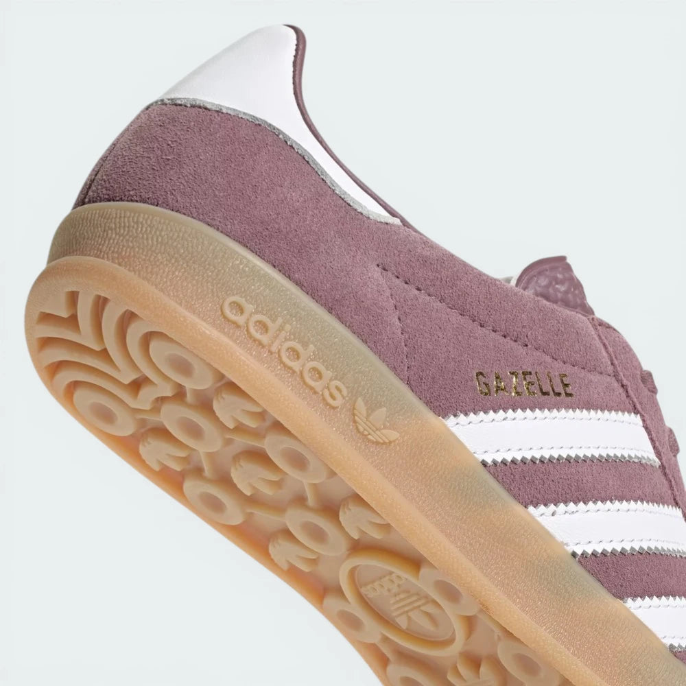 Detailed zoom on the serrated Three Stripes and the midsole stitching, showcasing the high-quality heritage construction.