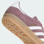 Detailed zoom on the serrated Three Stripes and the midsole stitching, showcasing the high-quality heritage construction.