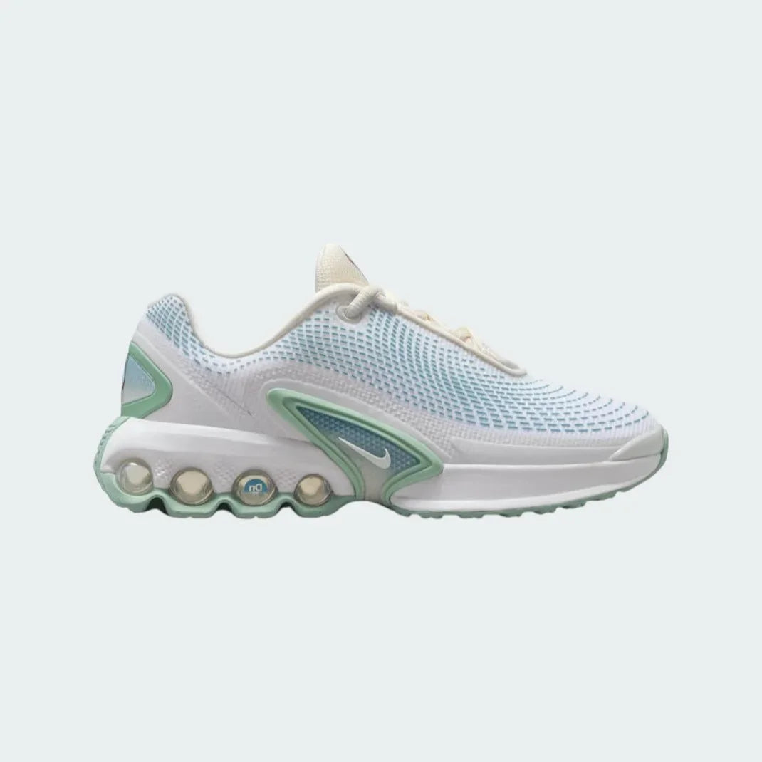 Nike Air Max DN Juniors' running trainers in soft pearl light green and off-white, side profile showing visible Dynamic Air unit in the heel, textured upper, and sleek silhouette.
