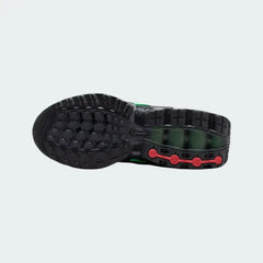 View of the outsole of the Nike Air Max DN Juniors' black running trainers, showing the durable rubber tread pattern and the unique design of the visible Dynamic Air pods.