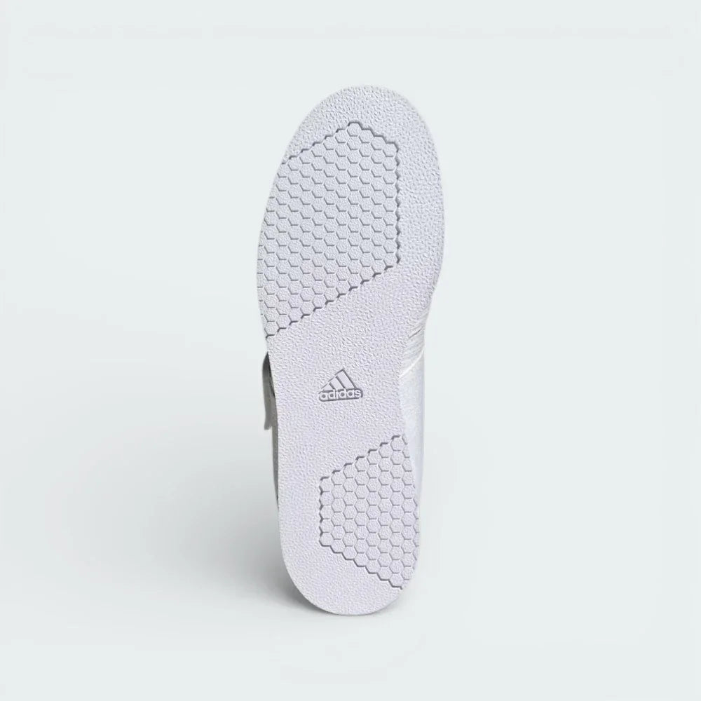 View of the flat rubber outsole, showcasing the textured grip pattern designed for maximum stability on gym floors.
