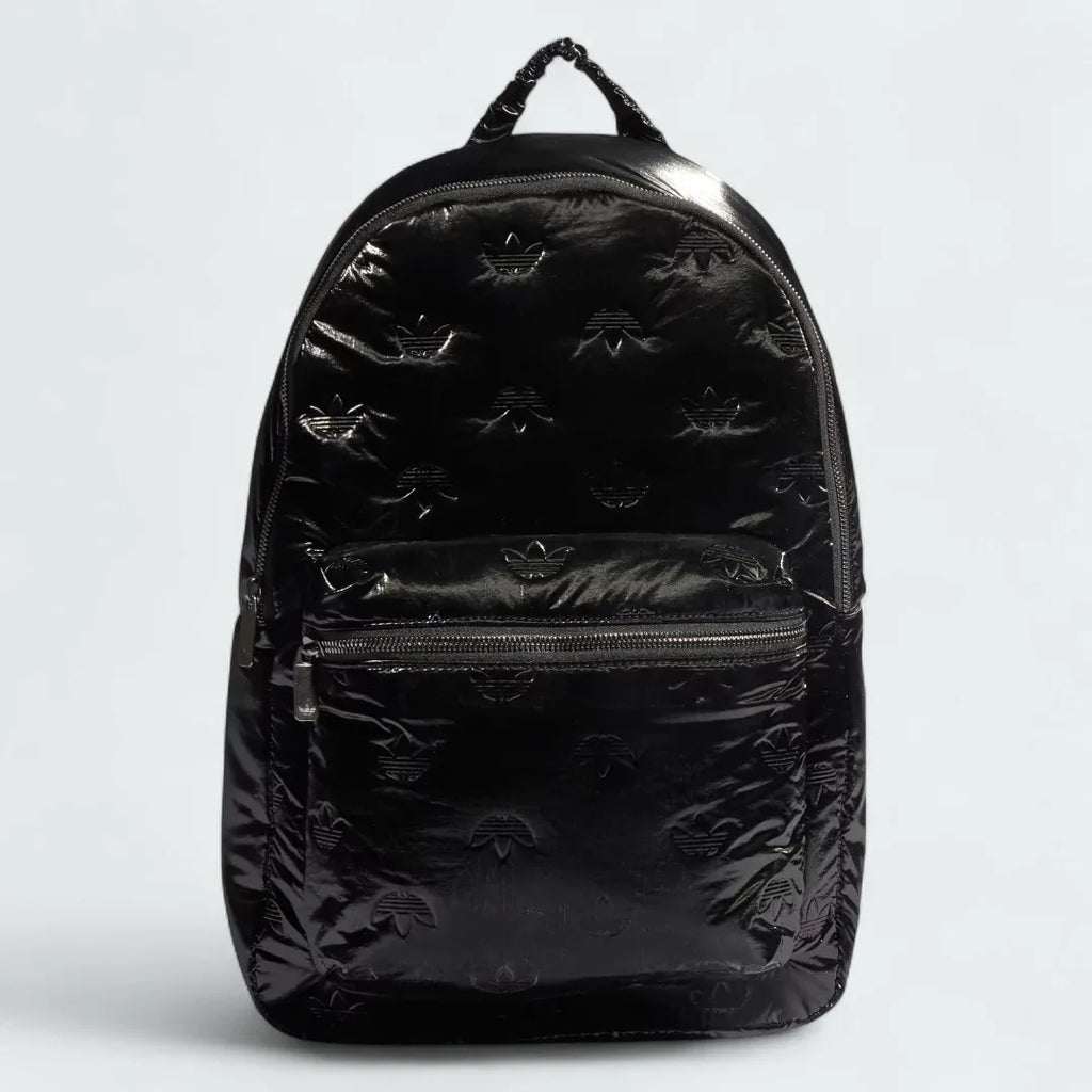 Adidas Puffy Satin Backpack in black, front view showing its sleek, padded silhouette, main zipper, and front zip pocket.