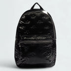 Adidas Puffy Satin Backpack in black, front view showing its sleek, padded silhouette, main zipper, and front zip pocket.