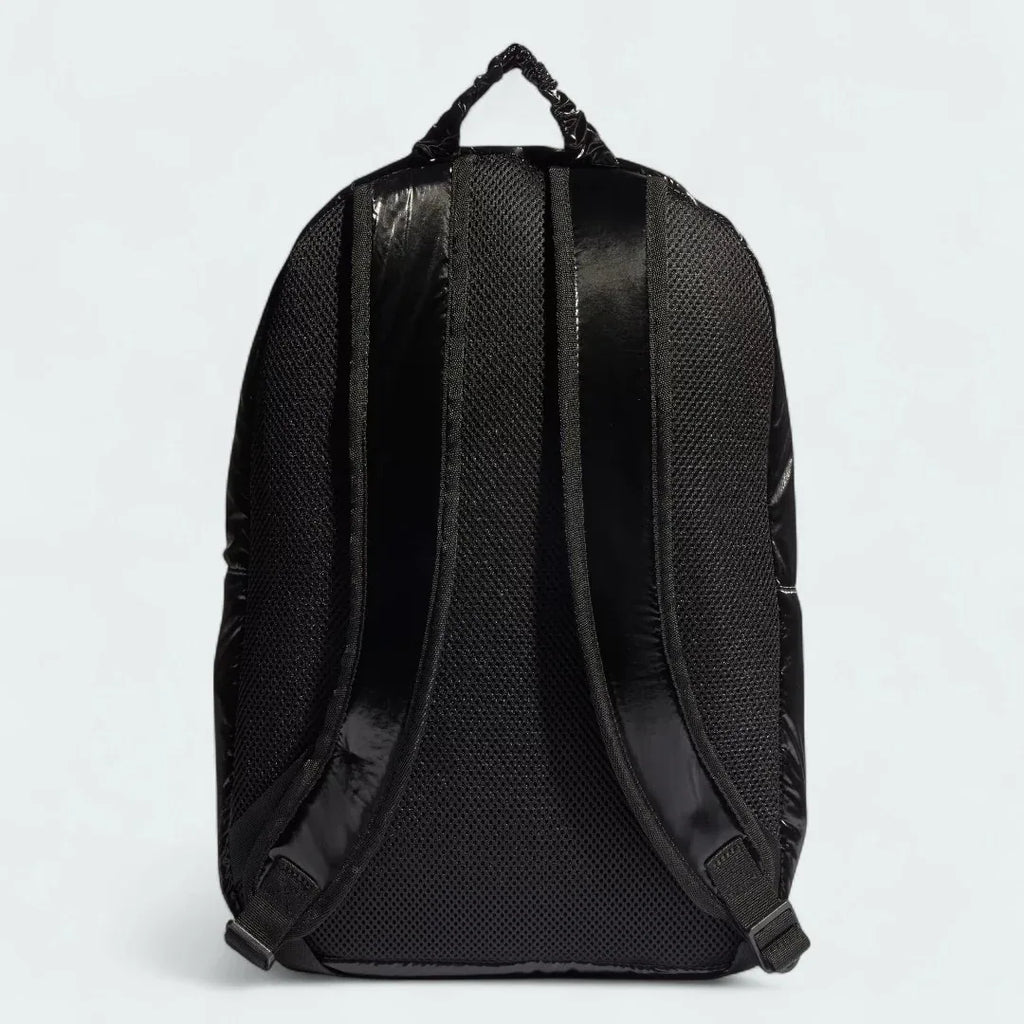 Adidas Puffy Satin Backpack in black, back view showing the adjustable shoulder straps and textured back panel.