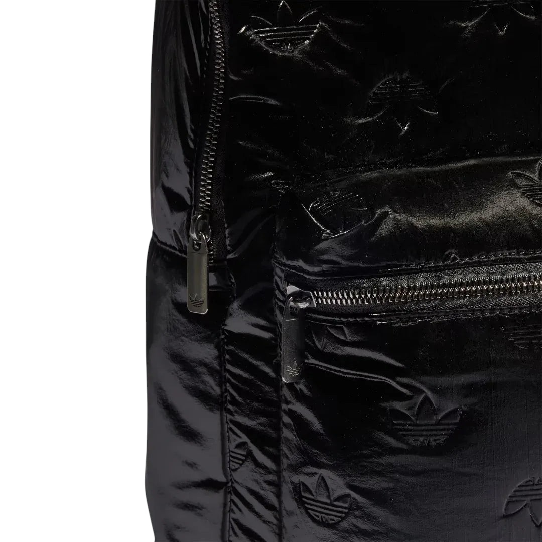 Close-up zoom on the fabric of the Adidas Puffy Satin Backpack in black, showing the smooth, slightly glossy satin texture and quilted effect.