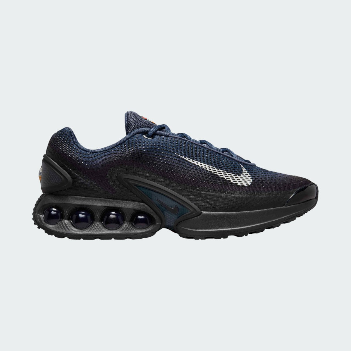 Nike Air Max DN Men's running shoes in dark navy with white accents, side profile showing visible Dynamic Air unit in the heel, textured upper, and sleek silhouette.