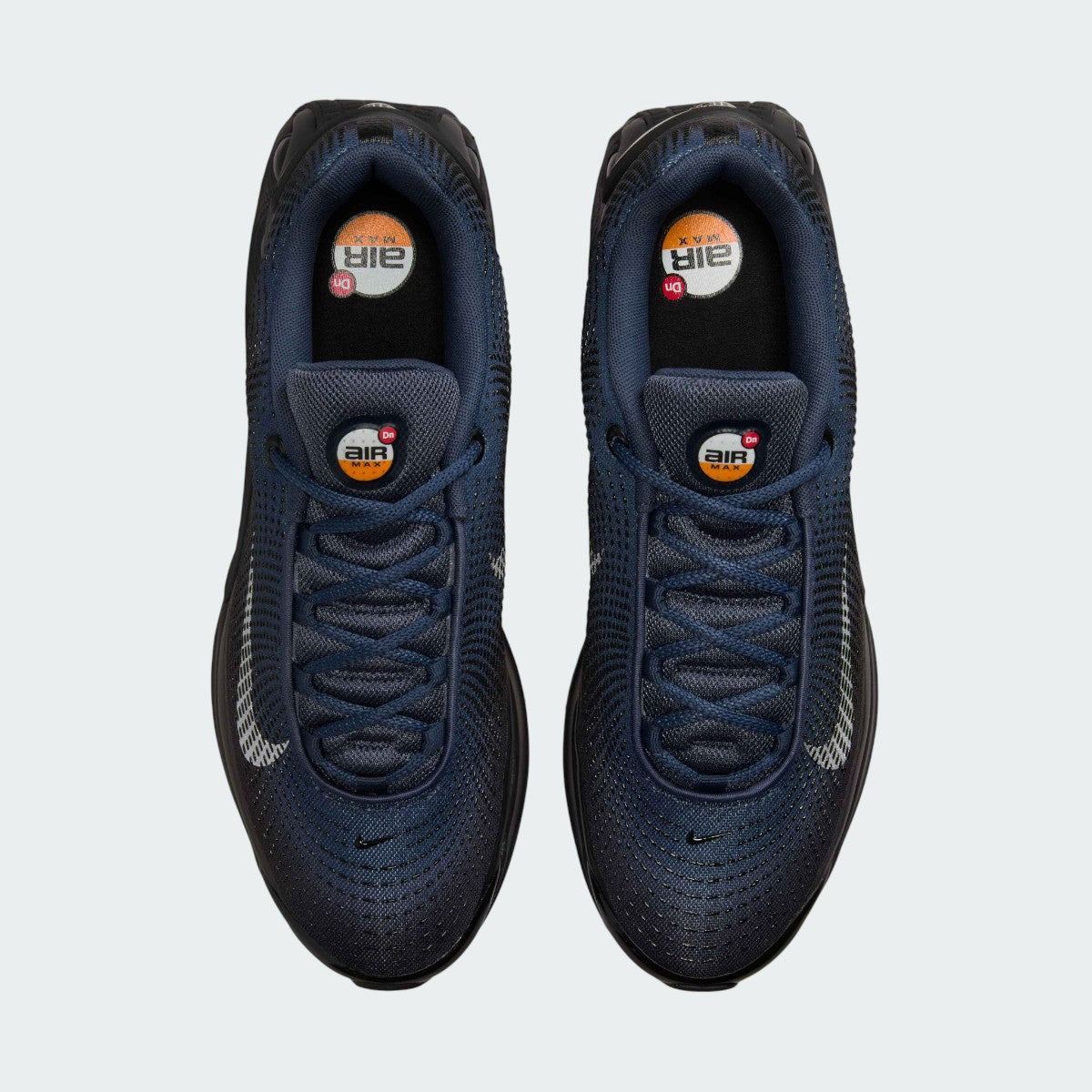Top-down view of a pair of Nike Air Max DN Men's running shoes in dark navy, highlighting their futuristic design and lace-up closure.