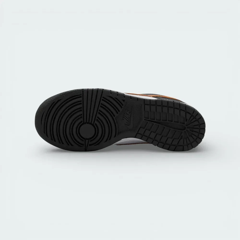 View of the black rubber outsole, showcasing the classic basketball pivot circle and multi-directional traction pattern.