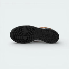 View of the black rubber outsole, showcasing the classic basketball pivot circle and multi-directional traction pattern.