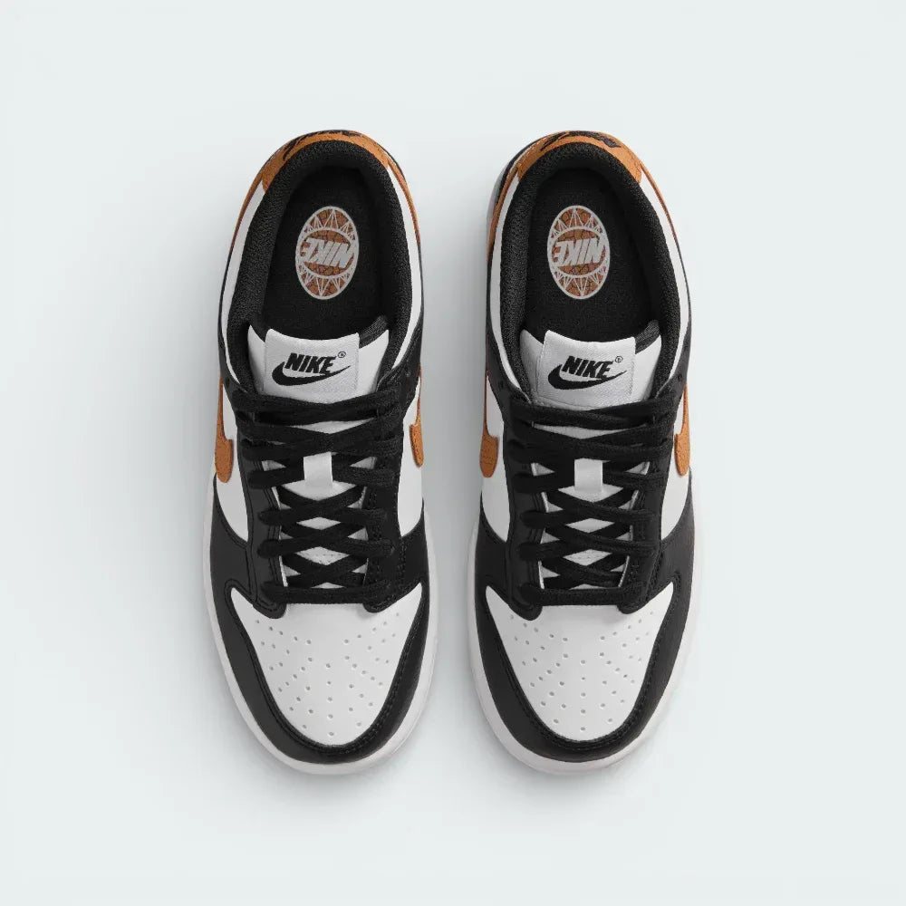 Top-down view of the trainers, highlighting the perforated white toe box and the contrasting black lacing system.