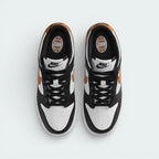 Top-down view of the trainers, highlighting the perforated white toe box and the contrasting black lacing system.