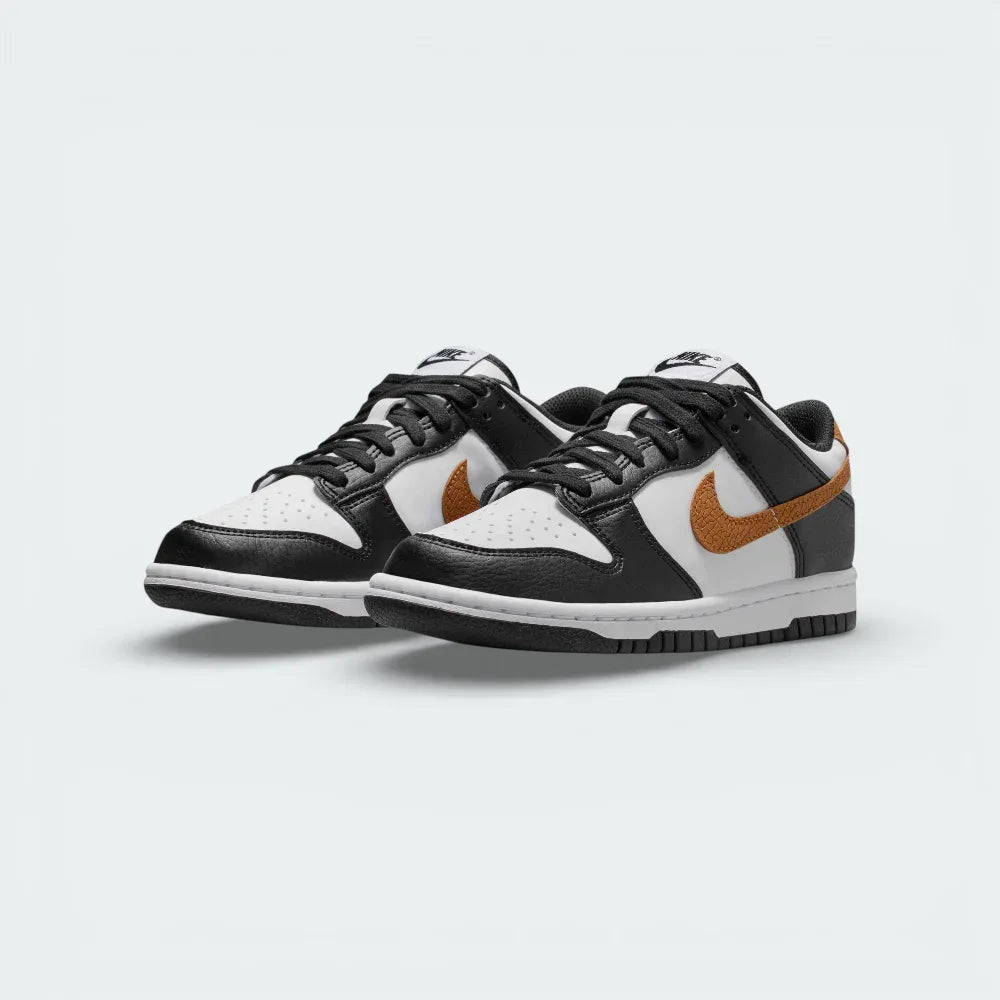 Angled shot of both Nike Dunk Low trainers side by side, showcasing the premium leather finish and the timeless Panda aesthetic.