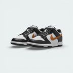 Angled shot of both Nike Dunk Low trainers side by side, showcasing the premium leather finish and the timeless Panda aesthetic.