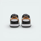 Rear view focusing on the black heel tab with white Nike embroidery and the structured leather heel counter.