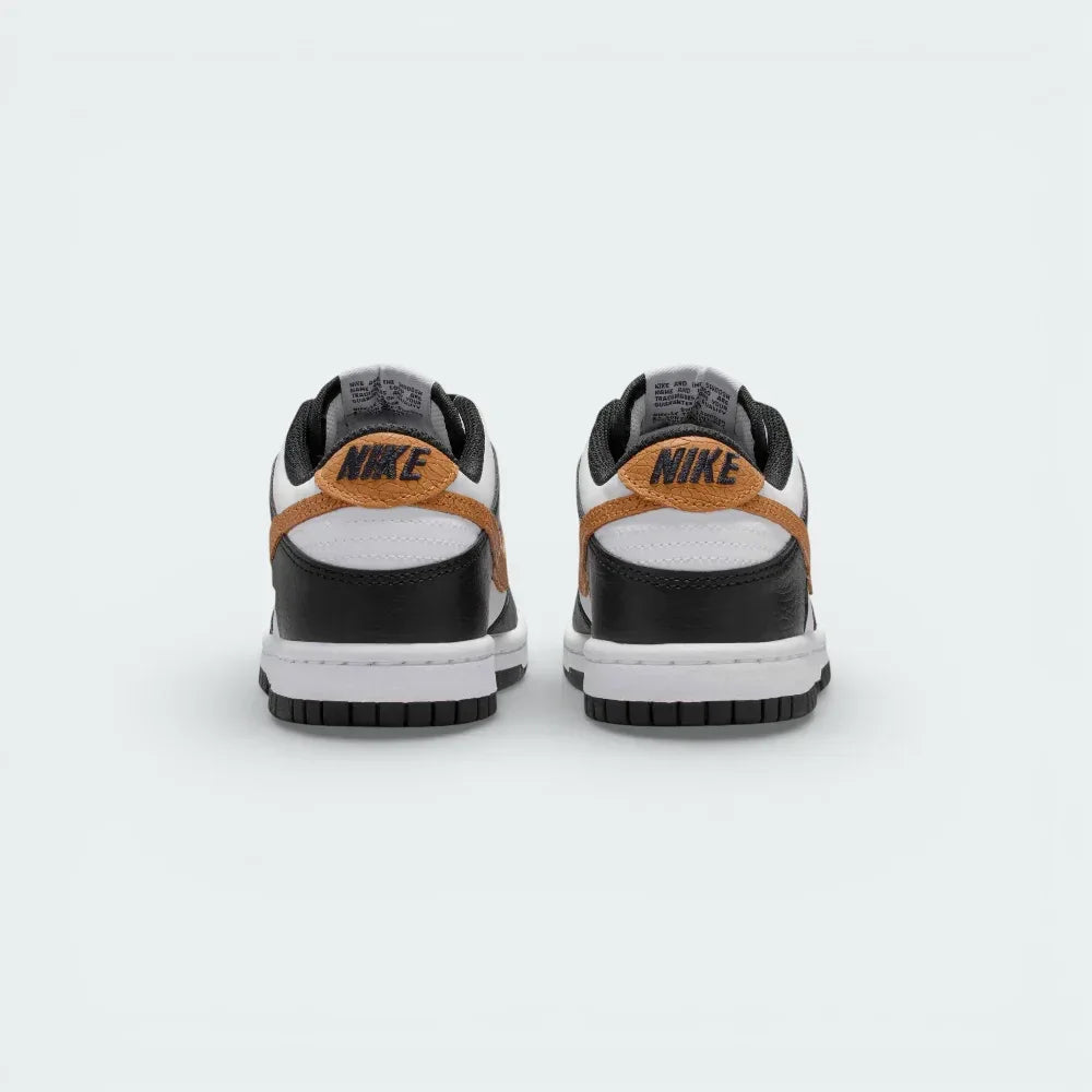 Rear view focusing on the black heel tab with white Nike embroidery and the structured leather heel counter.