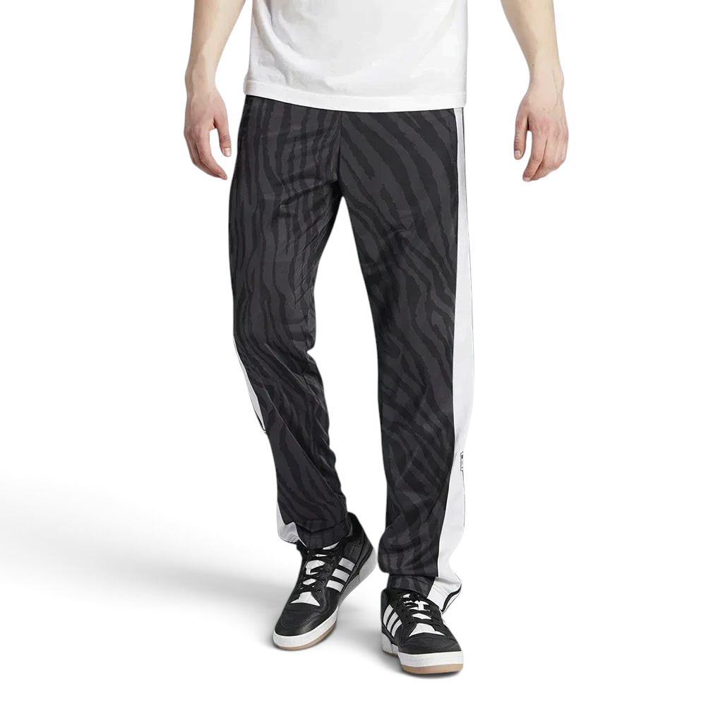 Adidas Adibreak Button Track Pants in black with a subtle animal print, front view showing the elastic drawcord waist and the full line of snap buttons down the side.