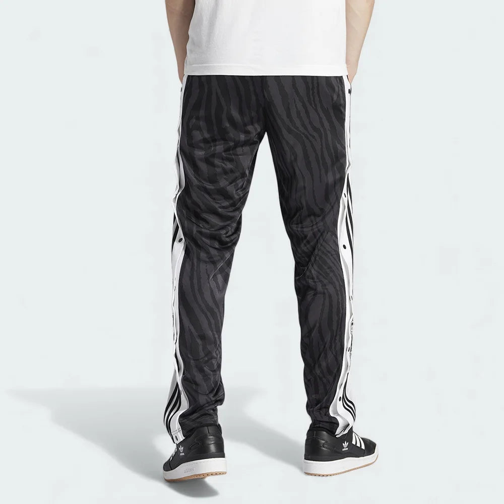 Adidas Adibreak Button Track Pants in black, back view showcasing the tapered leg and tonal animal print.