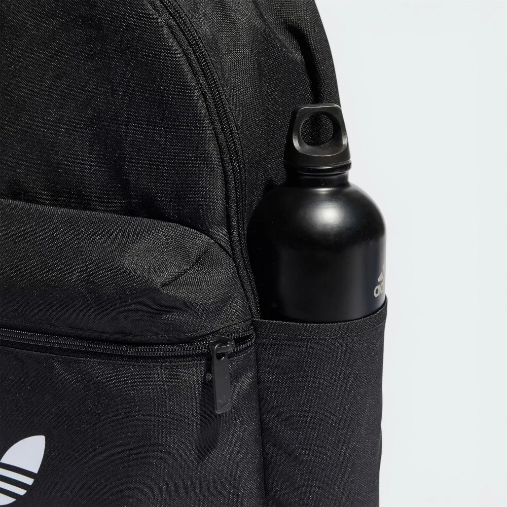 Details the premium twin-needle stitching tracking around the front zip pocket compartment, framing how the custom metal pull tabs slide smoothly under tension.