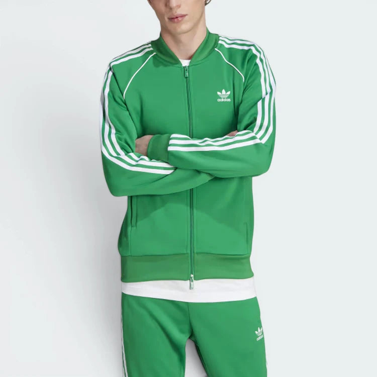 Highlights the high-velocity sweep of the continuous white 3-Stripes running flawlessly down the professional, deep emerald depth of the Green sleeve panels.