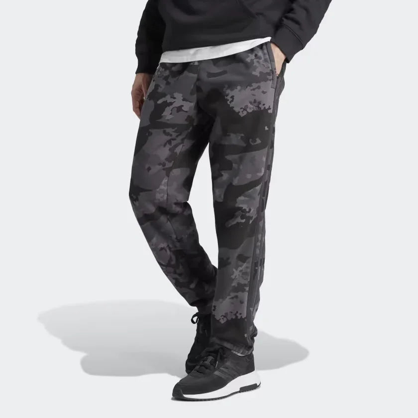 A pair of Adidas men's camouflage sweat pants with elastic waistband and zip pockets, in a gray and black color scheme. Main image