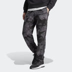 A pair of Adidas men's camouflage sweat pants with elastic waistband and zip pockets, in a gray and black color scheme.
