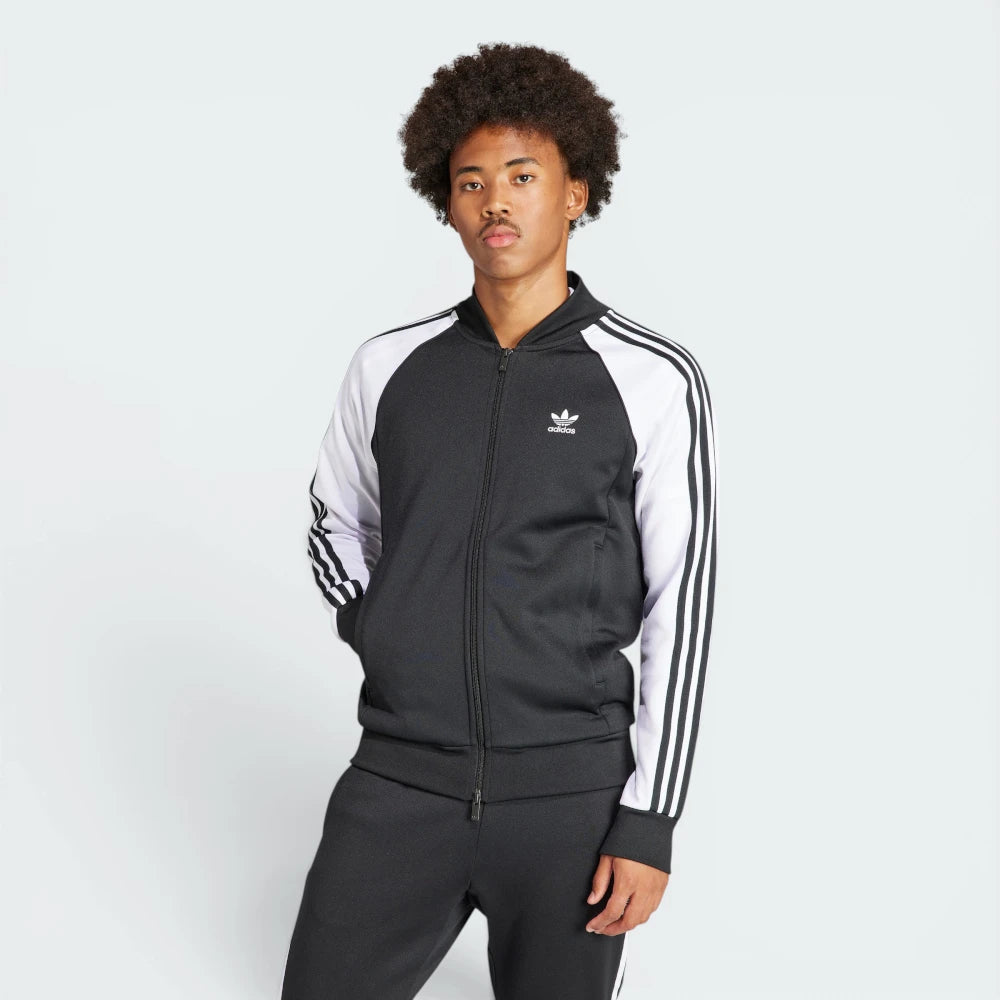 Highlights the high-velocity sweep of the white 3-Stripes running down the sleeves, showing the professional, deep matte black interlock fabric and the crisp white embroidered Trefoil logo.