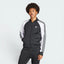 Highlights the high-velocity sweep of the white 3-Stripes running down the sleeves, showing the professional, deep matte black interlock fabric and the crisp white embroidered Trefoil logo.