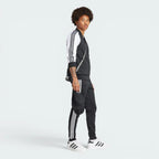 Emphasising the sharp visual contrast of the white fabric bands sewn perfectly parallel down the arm columns.