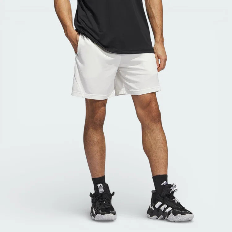 White adidas Badge of Sport Basketball shorts worn by a model looking from the front