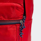 Details the premium precision of the stitching tracking around the front zip pocket, framing how the custom metal pull tabs slide smoothly under tension.