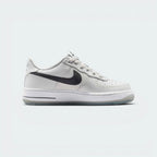 Highlights the high-velocity sweep of the anthracite leather Nike Swoosh, showing the professional, matte texture of the photon dust upper, the flashing contrast of the reflect silver accents, and the thick grey midsole wall.