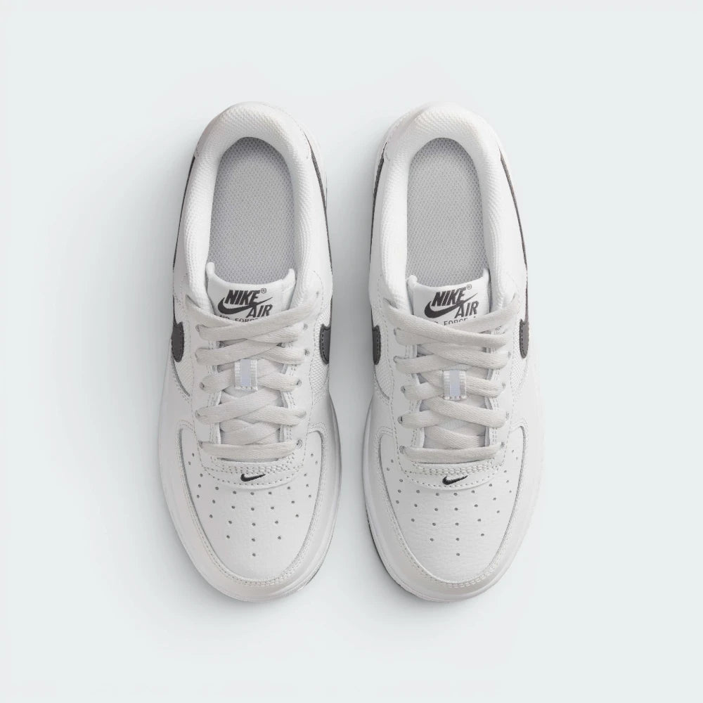 Focuses on the locked-in traditional lacing layout, displaying the perfect symmetry of the textile tongue, the branded tongue tab, and the neat rows of perforations guarding the front toe box area.