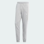 Overhead view of the joggers laid flat, highlighting the elastic waistband, drawcords, and the embroidered Trefoil logo.