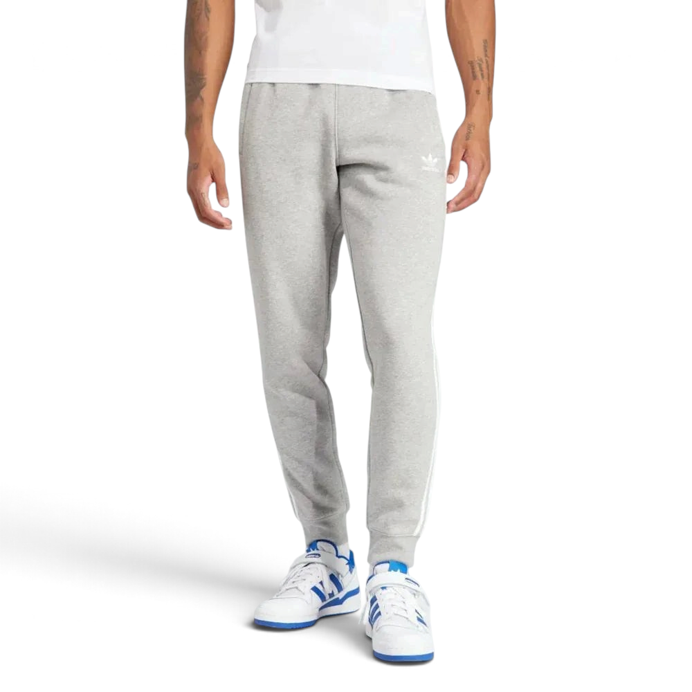 Front profile of the Adicolor 3-Stripes joggers, showing the slim-fit silhouette and the iconic contrast stripes running down